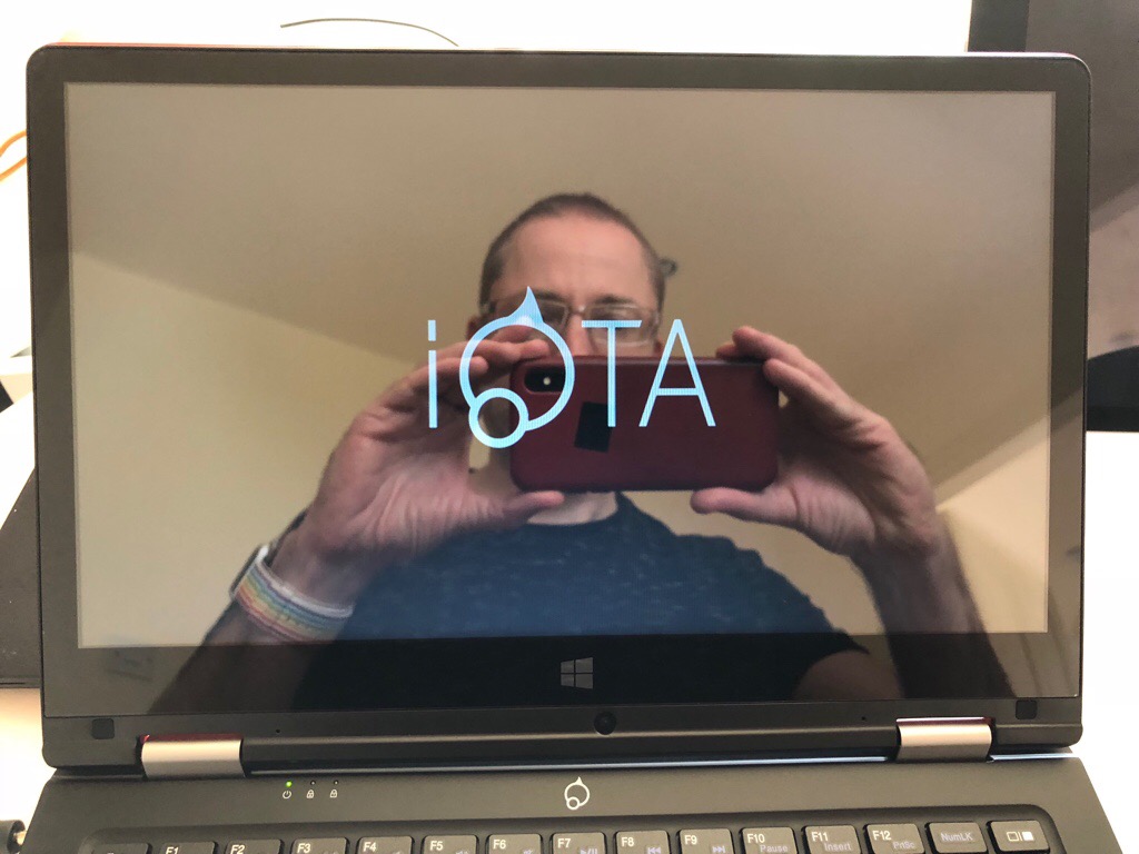 My reflection in the screen as I take a photo of the iOTA 360 as it boots.
