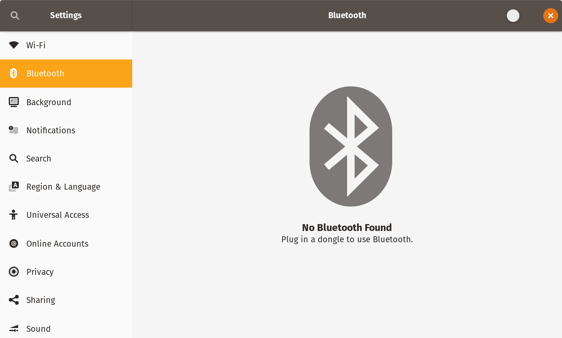 Bluetooth settings panel in Pop!_OS showing the Bluetooth logo and the message: “No Bluetooth Found. Plug in a dongle to use Bluetooth.” The switch normally used to turn Bluetooth on looks broken in the window’s top bar, with only the thumb showing.