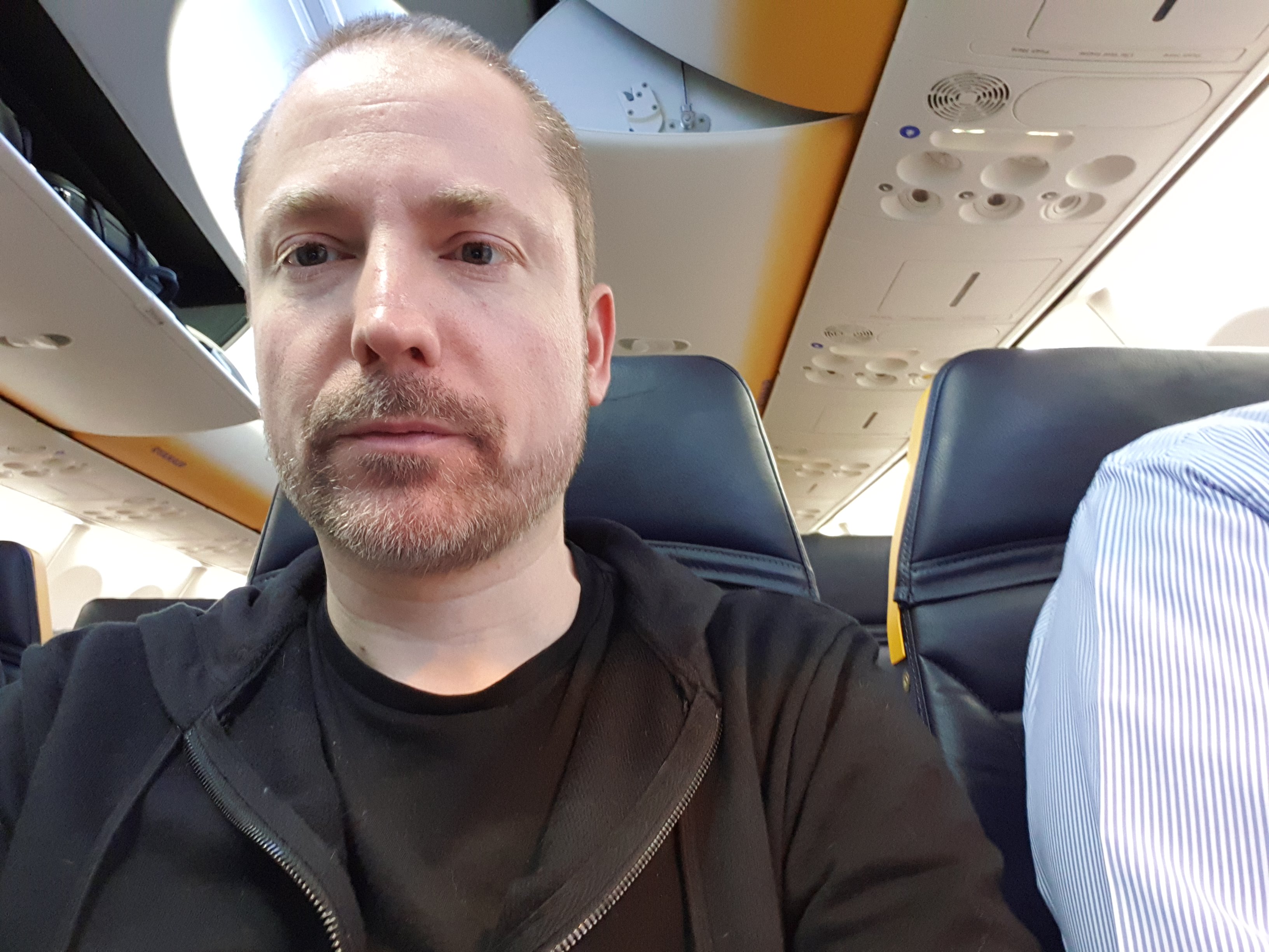 Photo of me on the plane looking sleepless.