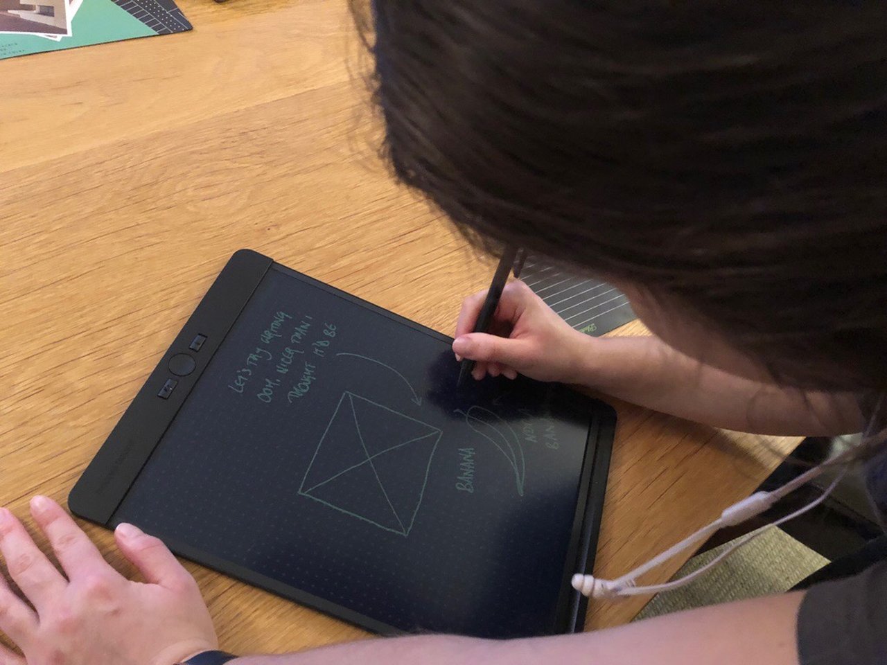 Photo of Laura writing on the Blackboard.