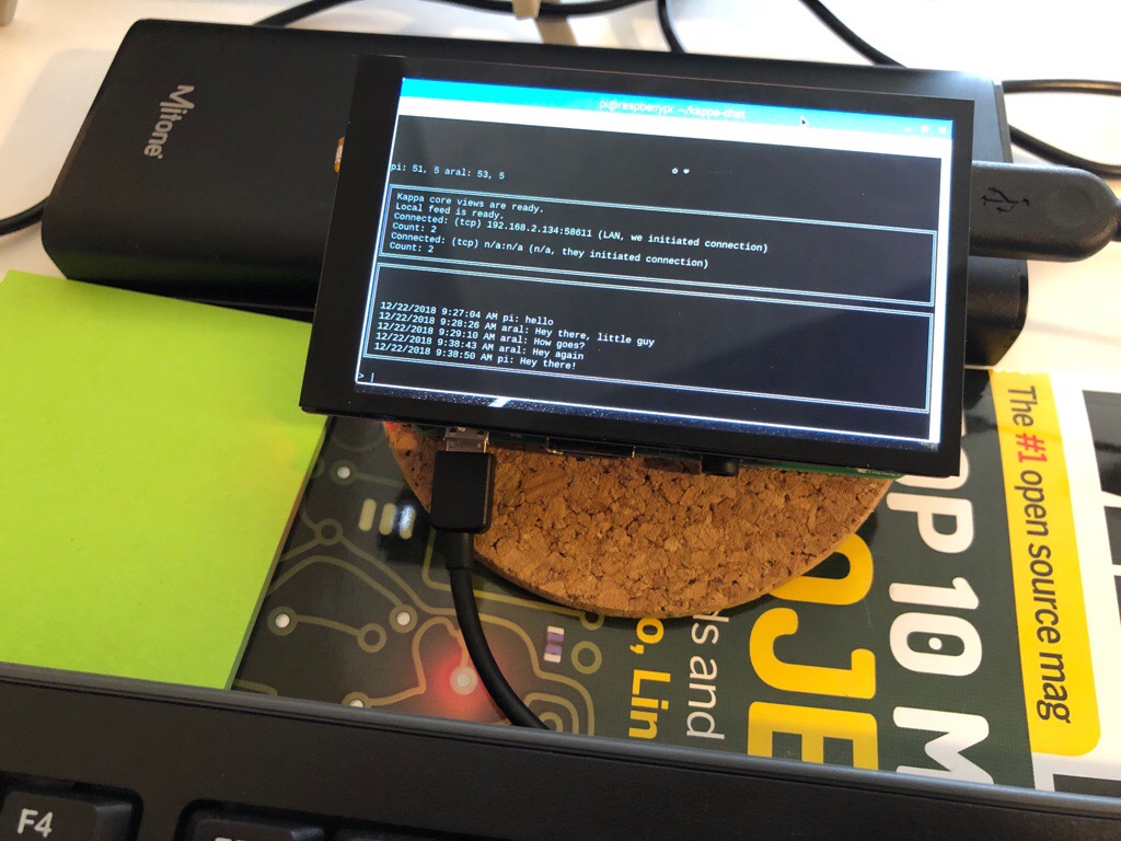 A Raspberry Pi 3B+ with a HyperPixel touch screen running a chat app in the terminal.