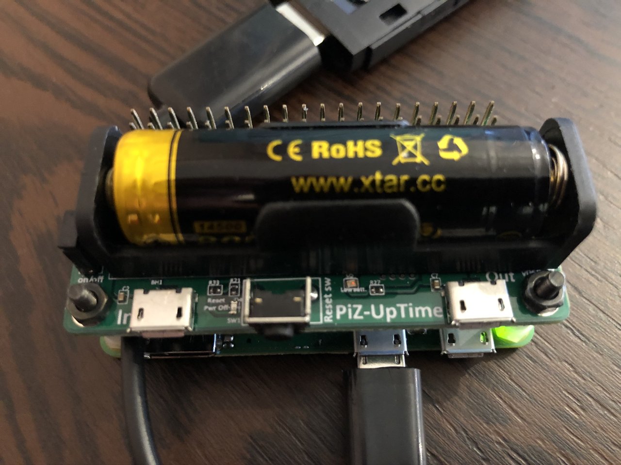 Photo of Prototype-01 on a table showing the battery module and LTE USB stick connected to the Raspberry Pi.