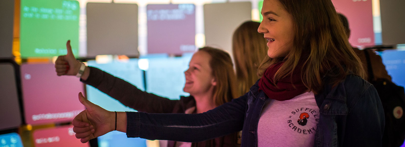 Kids give the thumbs up to tweets at the Be Democracy exhibit.